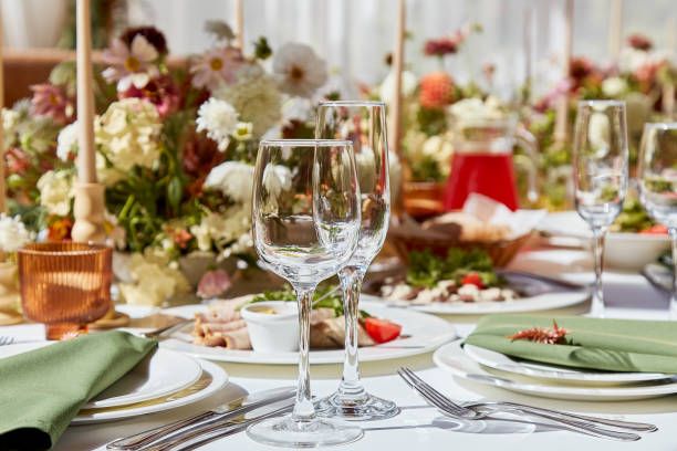 istock A sophisticated tableau arrangement on the table, adorned with candles and delicately placed flowers beneath the play of shadows. A wedding style reminiscent of Provence aesthetics. 1675561097