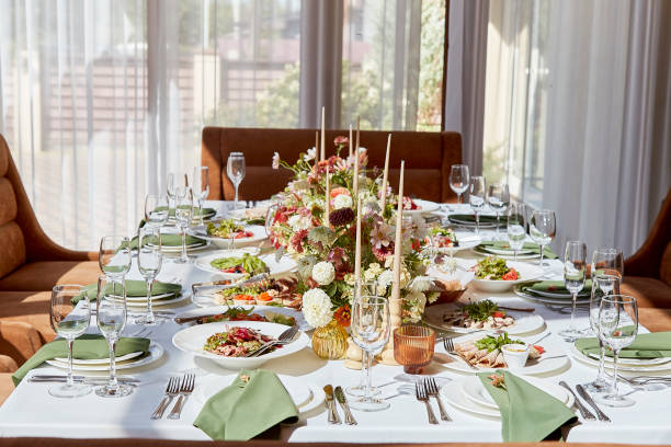 istock Elegant chamber table setting with candles and flowers arrangement under shadows. Provence aesthetics wedding style 1675561100