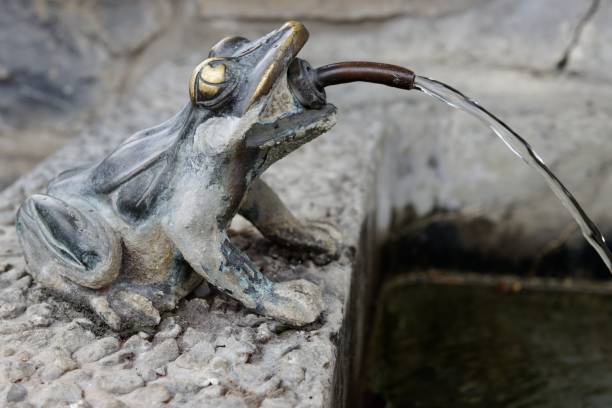 detail of one of the two monumental Tourny fountains in Lisbon's Rossio Square. The French ornamental style includes elements related to the sea: fish, shells, cables, anchors, children, gods and mermaids. The main sculptures are by French sculptor Mathurin Moreau (1822-1912) and the other figures and ornaments are by French sculptor and designer Michel Joseph Napoléon Liénard (1810-1870); Lisbon, Portugal