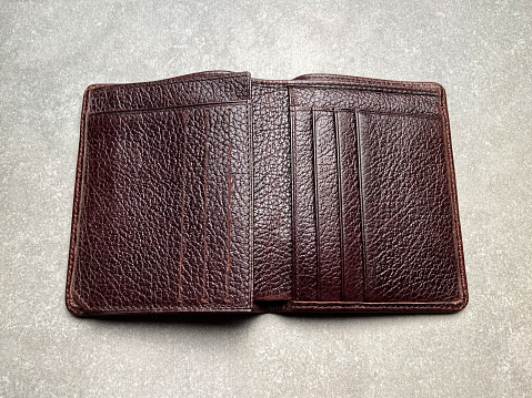 Open empty brown leather wallet