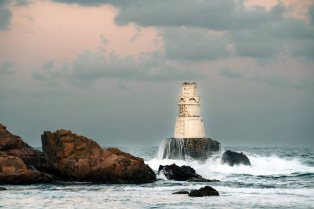 istock Big sea waves hitting a lighthouse 1675591574