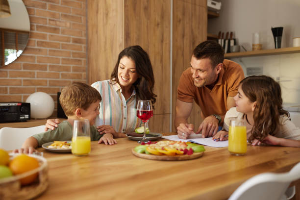 istock Young happy family talking during a healthy snack at dining table. 1675593769