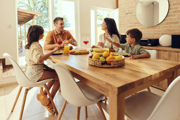 istock Happy family talking during a meal at dining table. 1675602764