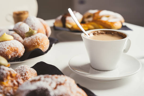 istock breakfast with cup of coffee and croissants on a white table. Front view 1675608245