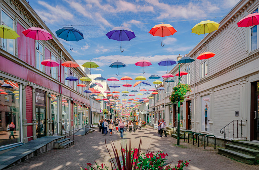 Trondheim, Norway - August 19 2022: An installation of colourful umbrellas above a street in the downtown of the city.