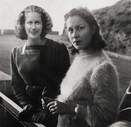 Two young women twin on a road in 1934. Sepia Toned.