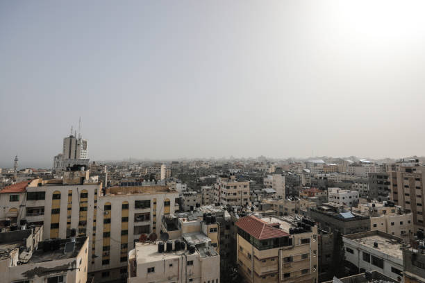 写真は、砂塵の波の間のガザ市の眺めを示しています - gaza strip ストックフォトと画像