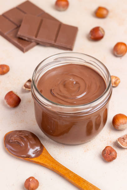istock Chocolate paste with nuts in a jar. Dessert. Vegetarian food. 1675669544