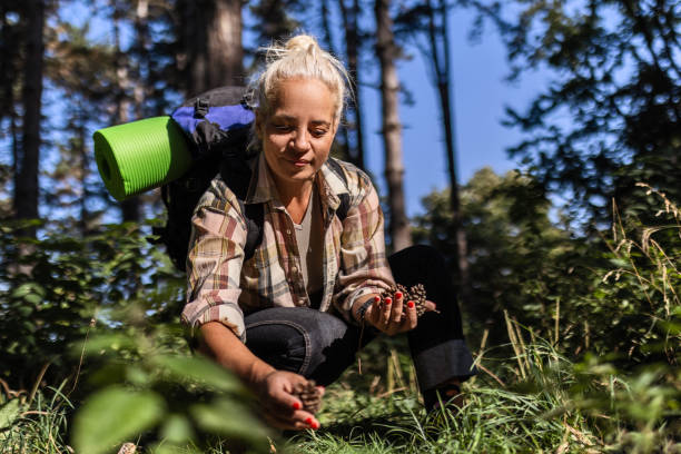 Woman in Forest Holding Pine Cones