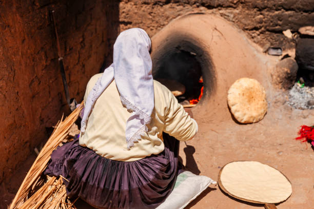 istock Moroccan woman making bread - khubz 1675691907