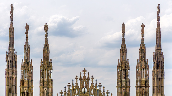 Milan, Milano, Italy. 05.03.2023. Symmetrical photo of sculptures on the roof of the Duomo Cathedral in Milan