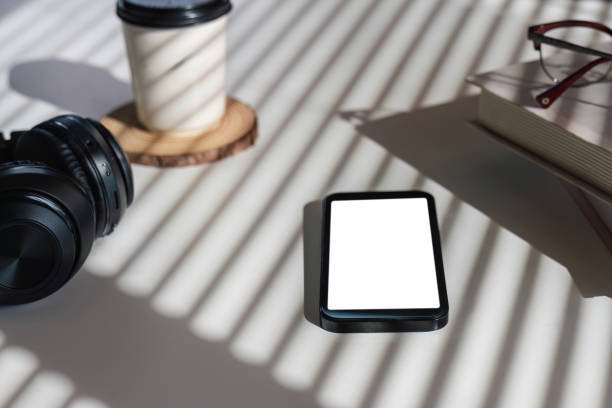 istock Flat lay home office desk. workspace with headphones, smartphone with empty screen mockup, coffee cup. Top view background. 1675709952