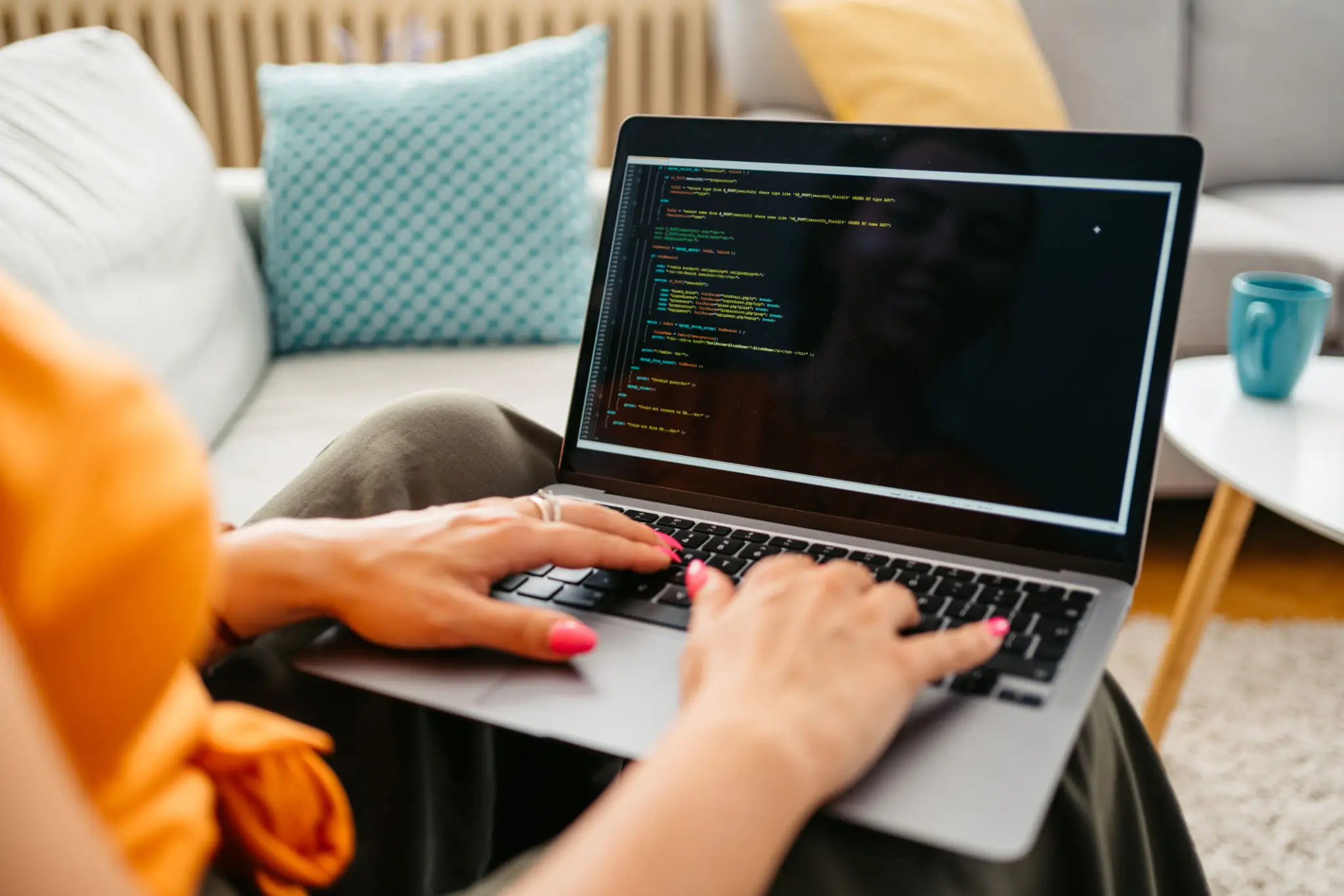 Young Woman Programming On A Laptop At Home