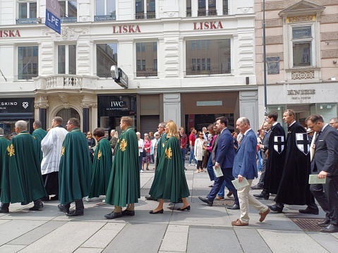 Vienna, Austria - June 8, 2023: Catholics filled the street in Graben square on Corpus Christi holiday. Religious ceremony marching on the Vienna street.