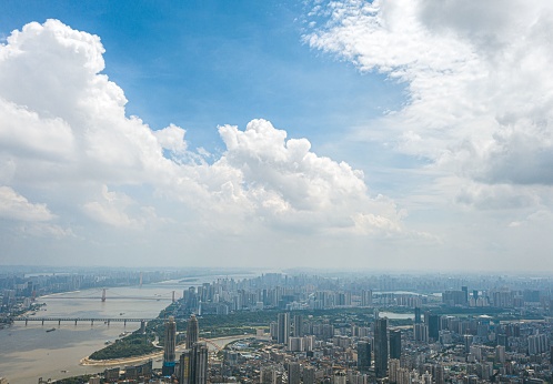 An aerial view of Wuhan, China on a midsummer day, with billowing cumulonimbus clouds in the sky