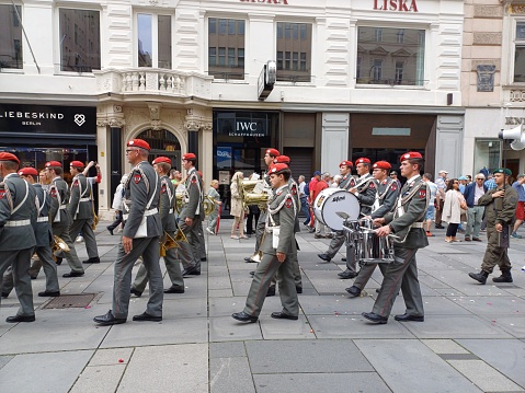 Vienna, Austria - June 8, 2023: Guards Band Vienna - The military band with drum, trumpet marching in procession on Corpus Christi holiday of catholics, in Graben square, Vienna city.