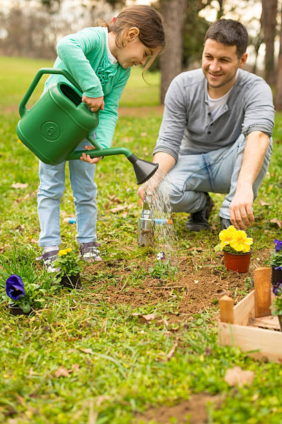 istock Father and daughter planting flowers 167573621