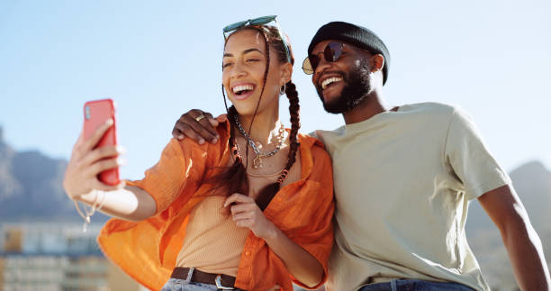 couple, bonding and phone selfie on city building rooftop on new york summer holiday, travel vacation date or social media memory. smile, happy or black man and woman on mobile photography technology - cool glasses sunglasses fashion imagens e fotografias de stock