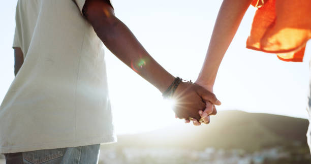 istock Interracial couple, bonding or holding hands in support, trust or security in Lisbon city, Portugal. Zoom, black man or woman in solidarity, love or unity on summer holiday vacation in relax location 1675740274