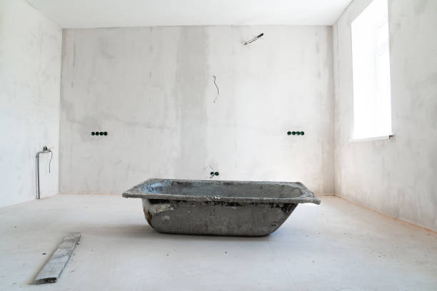 istock an old bathtub with cement mortar in A room in a house under construction. 1675745562