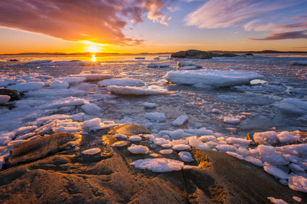 Sunset at the sea with ice and snow. Archipelago of Gothenburg, Sweden