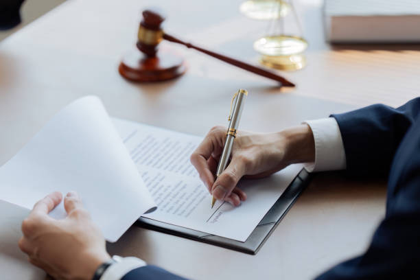 Lawyers or judges sign documents in accordance with legal and fair terms of agreement Lawyers or judges sign documents in accordance with legal and fair terms of agreement. legal document stock pictures, royalty-free photos & images