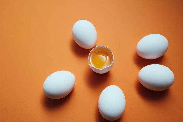 istock White eggs and egg yolk on the yellow background. 1675761242