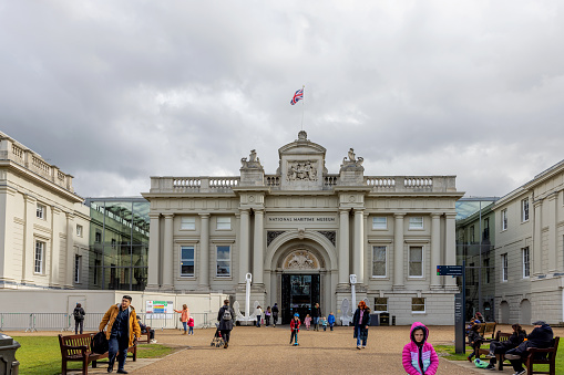 Entrance to the National Maritime Museum in London. England. With people walking.