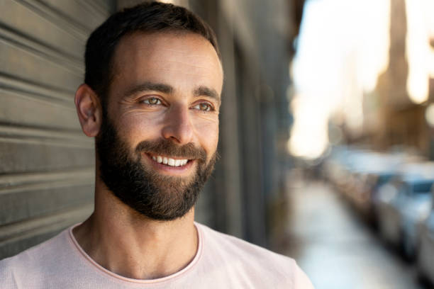 istock Smiling middle aged hispanic man looking away standing on the street, copy space 1675780549