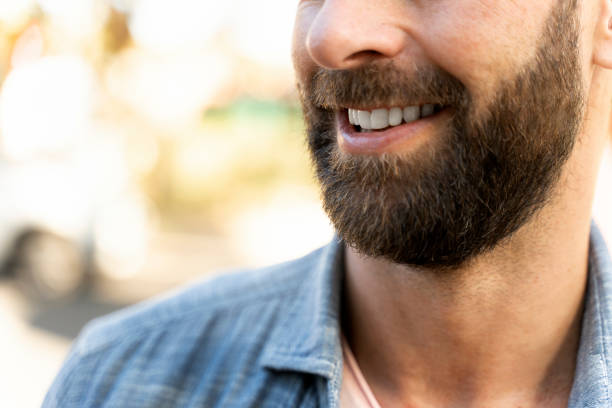 Closeup portrait of smiling bearded customer after barber shop service, selective focus