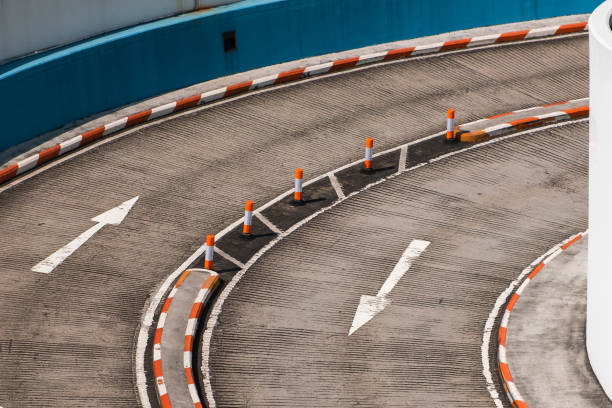 istock two lane road curve with direction arrows on asphalt 1675780814