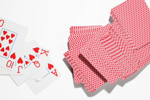 istock Stack of playing cards and Flush Royal hearts suit on a white background. 1675781426