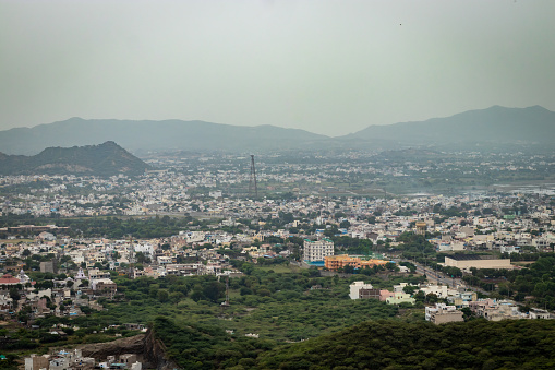crowded city houses landscape with misty mountain background at morning from flat angle image is taken at ajmer rajasthan india