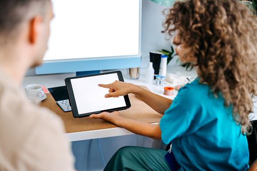 Patient in wheelchair talking to doctor