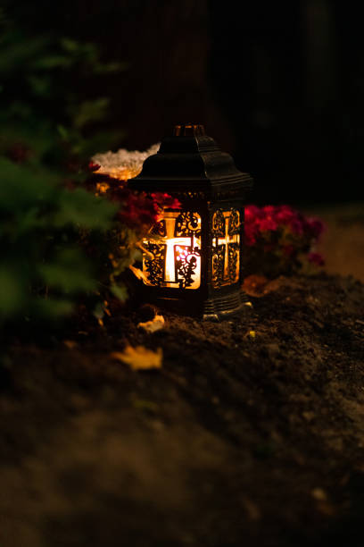 istock night garden lamp lantern candle fire light landscape single object in cemetery soft focus concept of vertical outdoors photo 1675795554
