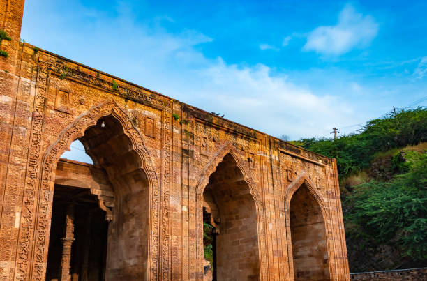 istock ancient grand mosque called Adhai Din Ka Jhonpra vintage architecture with bright blue sky at day 1675798020