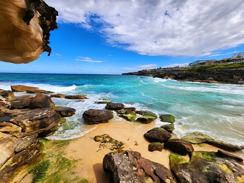 Coogee to Bondi coastal walk, Sydney, Australia. Below view, from a rocky and sandy bay, seaside.