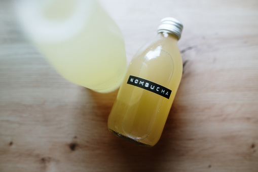 A small glass bottle with kombucha drink