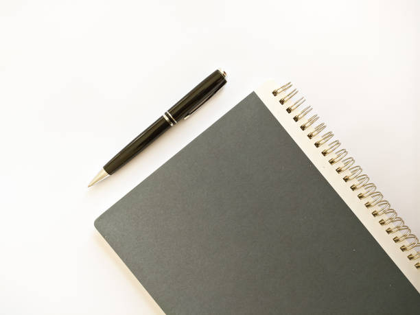 istock elegats notebook and balck pen on white background, back to school concept 1675821096