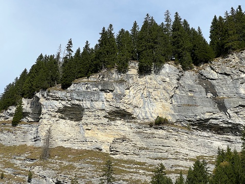 Steep stone cliffs and vertical rocks above the reservoir lake Panixersee (Lag da Pigniu) or Panixer Lake on the slopes of the Glarus Alps mountain massif, Pigniu-Panix - Canton of Grisons, Switzerland (Schweiz)