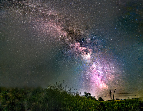 In the foreground is gras and in the background you can see the bright Milky Way.