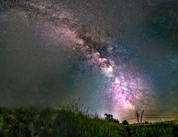 In the foreground is gras and in the background you can see the bright Milky Way.