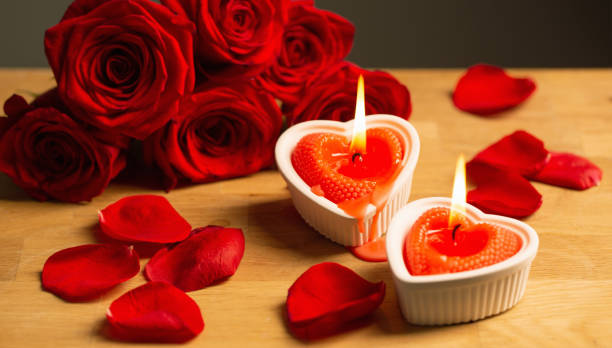 istock red roses with burning candles on dark background 1675841200