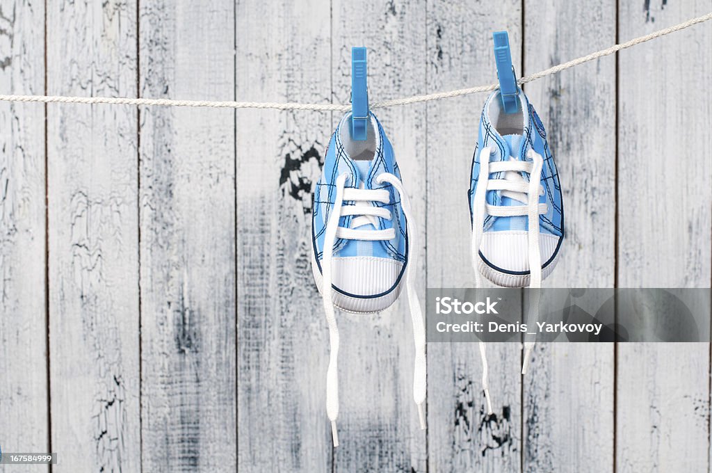 Baby shoes hanging on the clothesline. Beauty Stock Photo