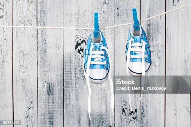 Baby Shoes Hanging On The Clothesline Stock Photo - Download Image Now - Beauty, Blue, Brown