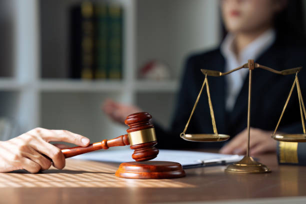 istock Lawyer makes an appointment to talk with a client in the background and a handle holding a lawyer's hammer 1675850451