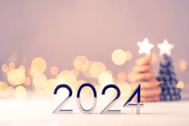 istock Metal numbers 2024 on table with bokeh lights. 1675859882