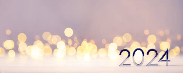 istock Metal numbers 2024 on table with bokeh lights. 1675860388