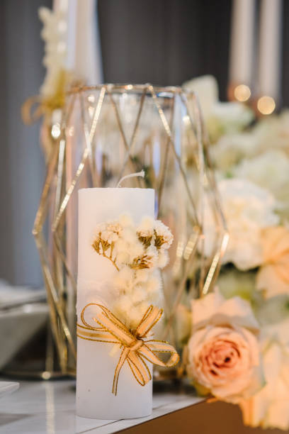 istock Wedding setup detail. Banquet decoration in hall restaurant. Luxury reception. Festive table decorated composition flowers and candle in party area closeup. Golden geometric decorative elements decor. 1675866073