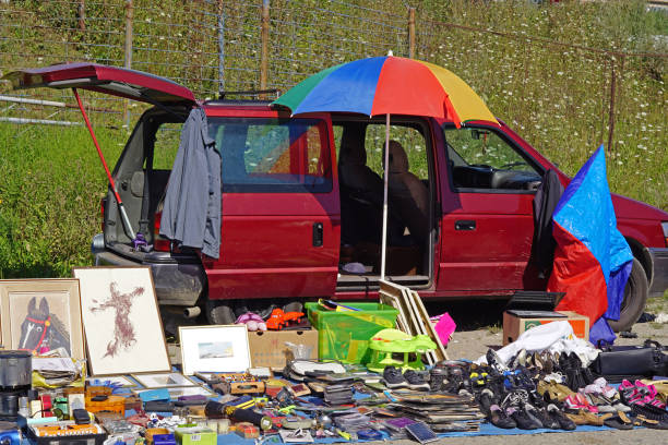 Belgrade, Serbia - August 1, 2020: Used old second hand goods pictures shoes and toys from minivan at flea market.